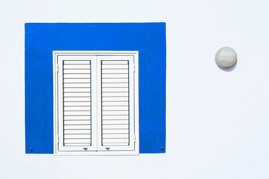 White plantation shutters installed in a bright room