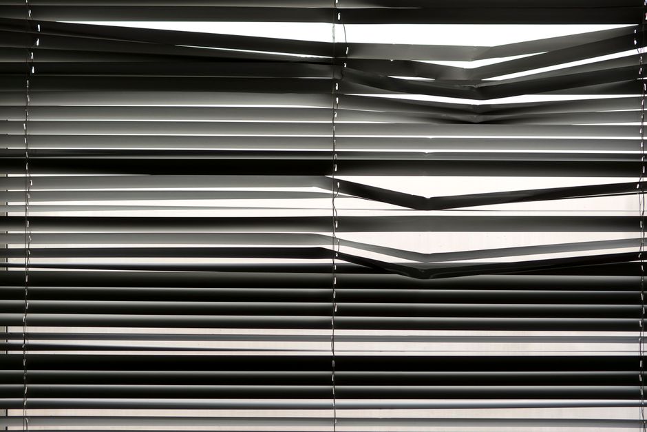 Rich wooden venetian blinds and elegant custom drapes